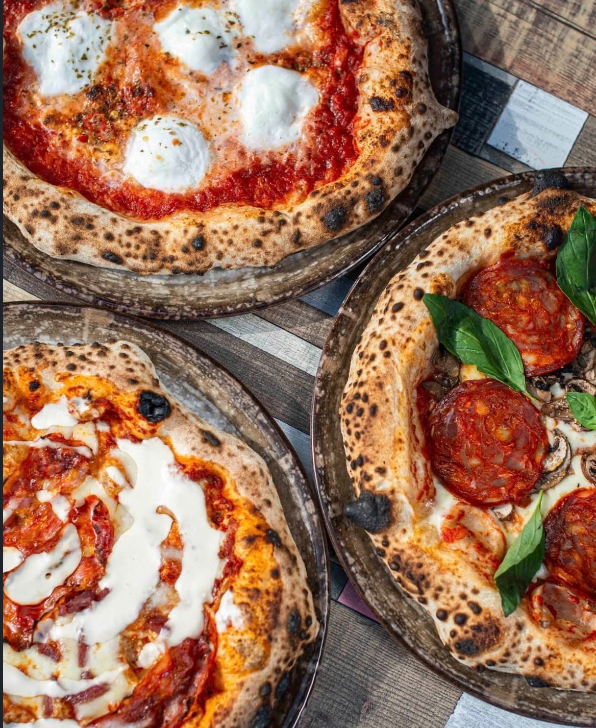a pizza on a cutting board with a wooden spatula